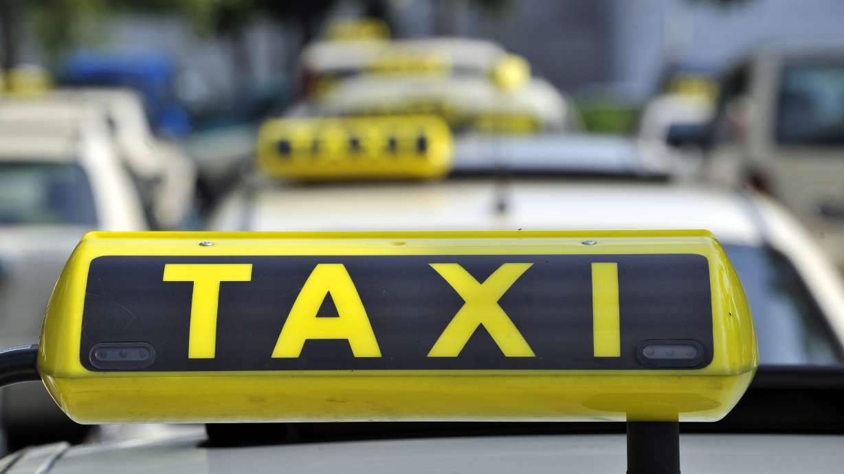 A taxi driver was arrested in Salt Lake City Wednesday after police say he intentionally hit another vehicle because he believed he was being followed and then punched an officer.