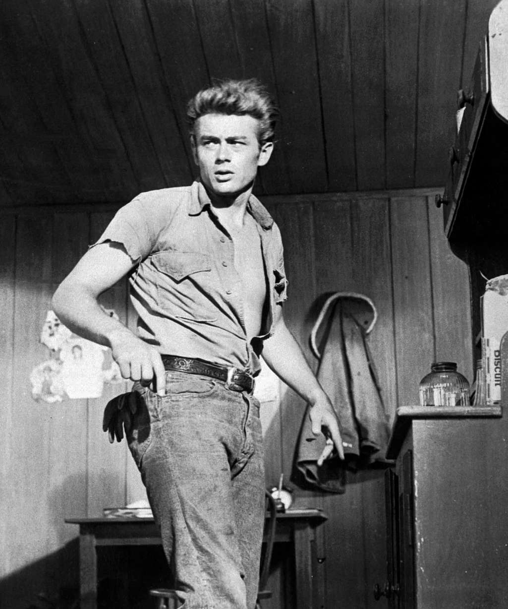 This 1955 file photo shows actor James Dean. Until the 1950s, jeans had been called overalls or waist overalls, but after teens started referring to them as jeans, Levi's began using the moniker in ads and packaging. Around the same time, jeans took on a bad-boy image, popularized by teen rebels like James Dean and Marlon Brandy, which led many schools to ban kids from wearing them to class. (AP Photo/File)