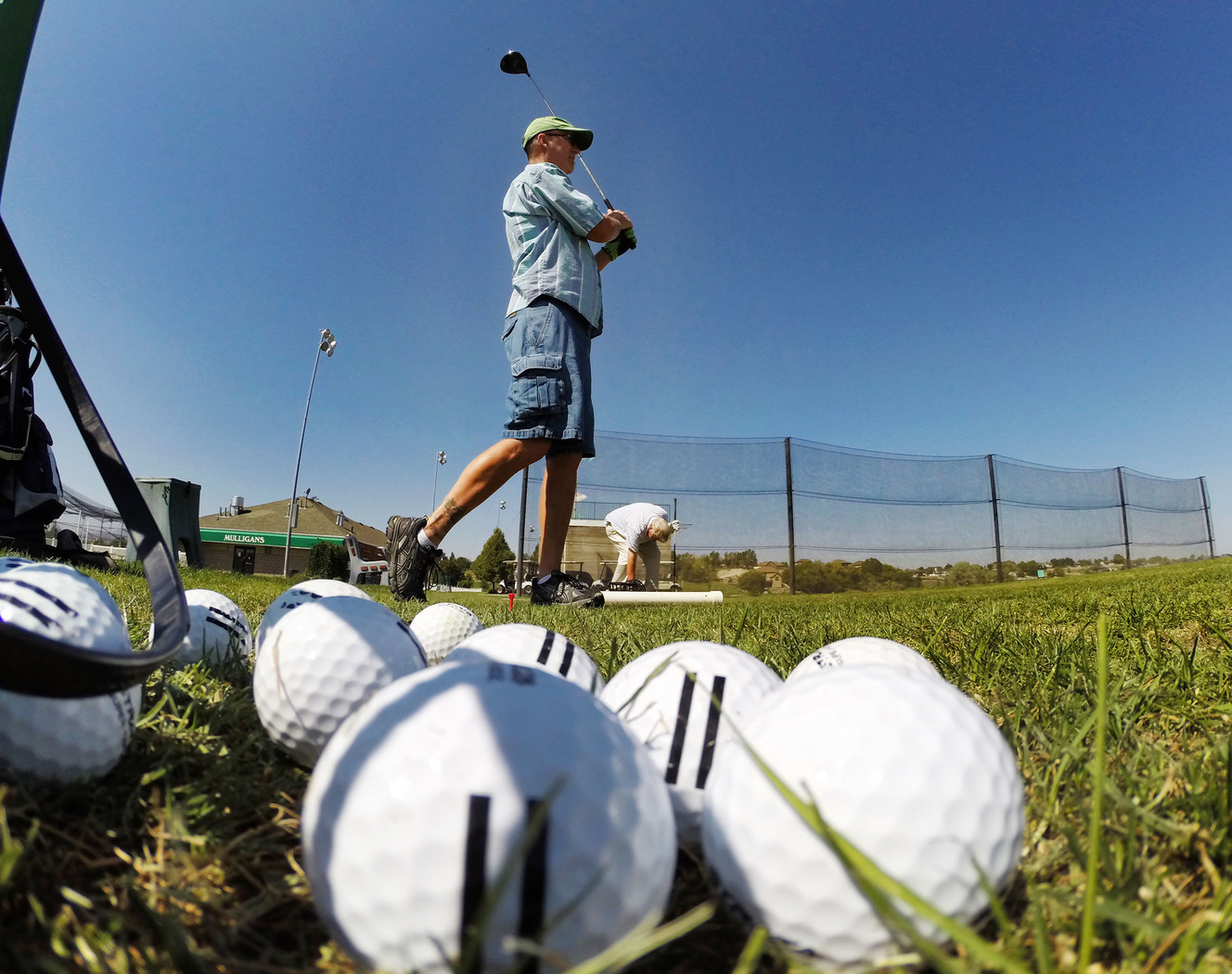 Mike Geer watches his ball as golfers enjoy Mulligans Tuesday, Sept. 2, 2014, in South Jordan.