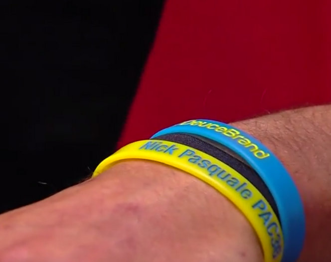 Travis Wilson wearing a bracelet that holds his friends name.