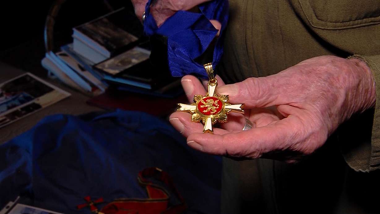 Gail Halvorsen shows off one of his medals he received. Halvorsen has been honored by several countries for his acts of service.