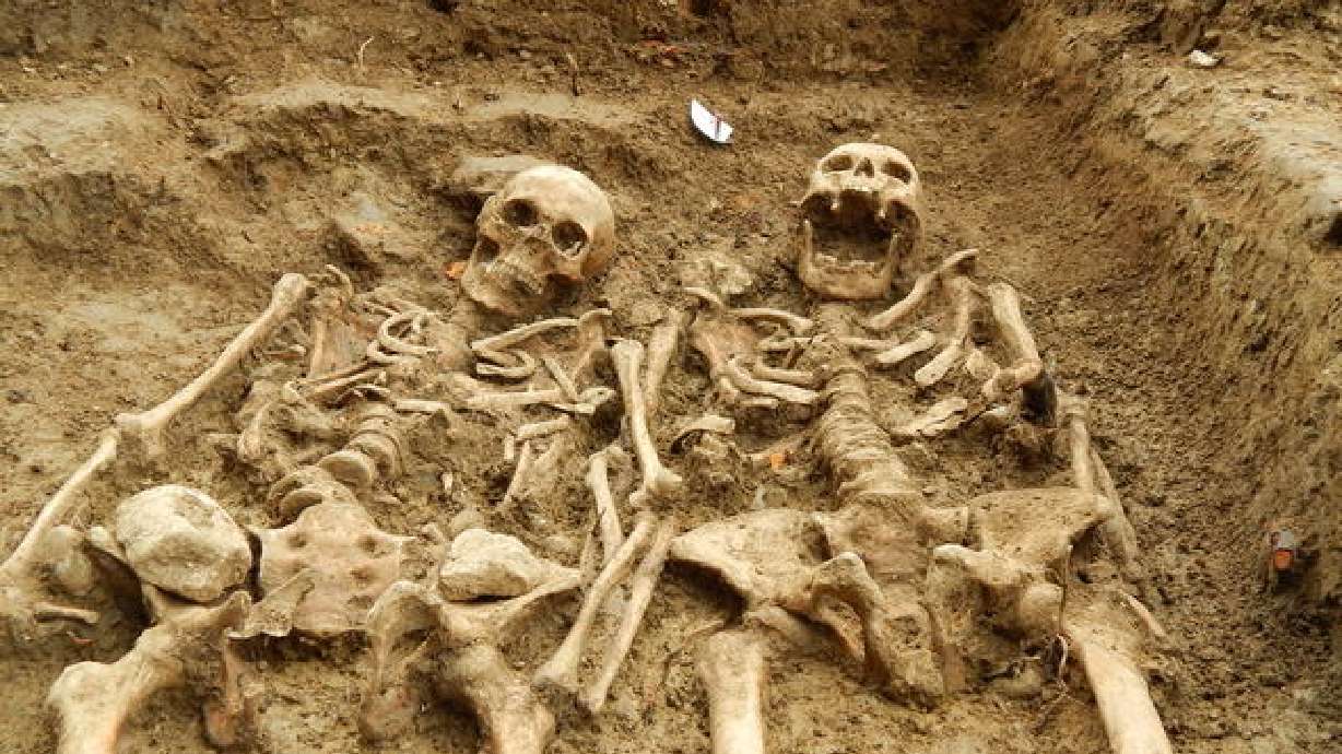 Skeletons found 'holding hands' after 700 years