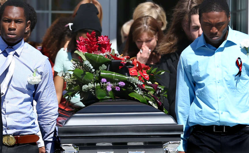 Susan Hunt, center, weeps as pallbearers carry the casket of son, Darrien, after his funeral service in Saratoga Springs on Thursday, Sept. 18, 2014. Darrien Hunt, who was black, was shot and killed on Sept. 10 by Saratoga Springs police. Police say Hunt was carrying a samurai-type sword and that he lunged at officers during an altercation at a strip mall in Saratoga Springs.