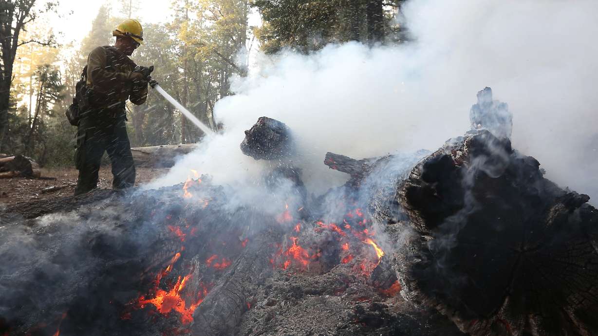 Teams assess damage as California wildfire burns