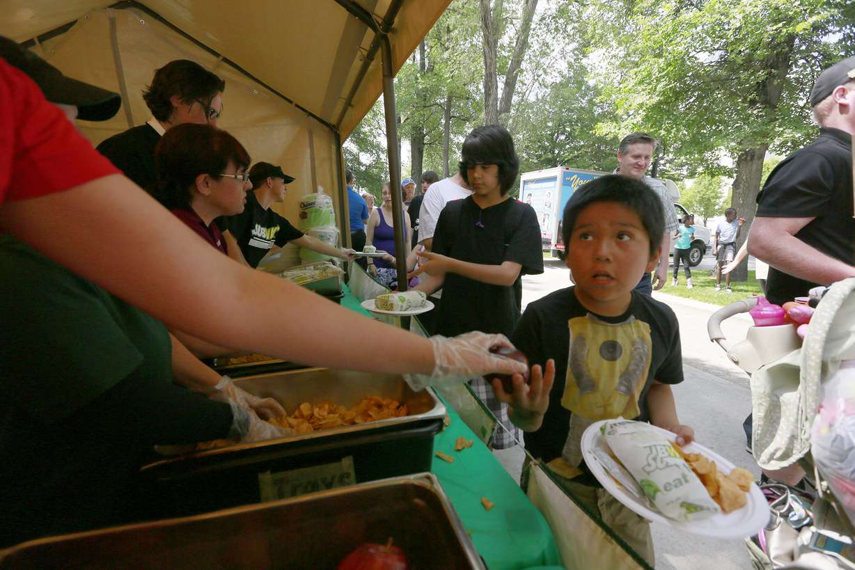 Subway workers give away sandwiches to the homeless during the annual "Day of Giving" at Pioneer Park Wednesday, May 28, 2014 in Salt Lake City.