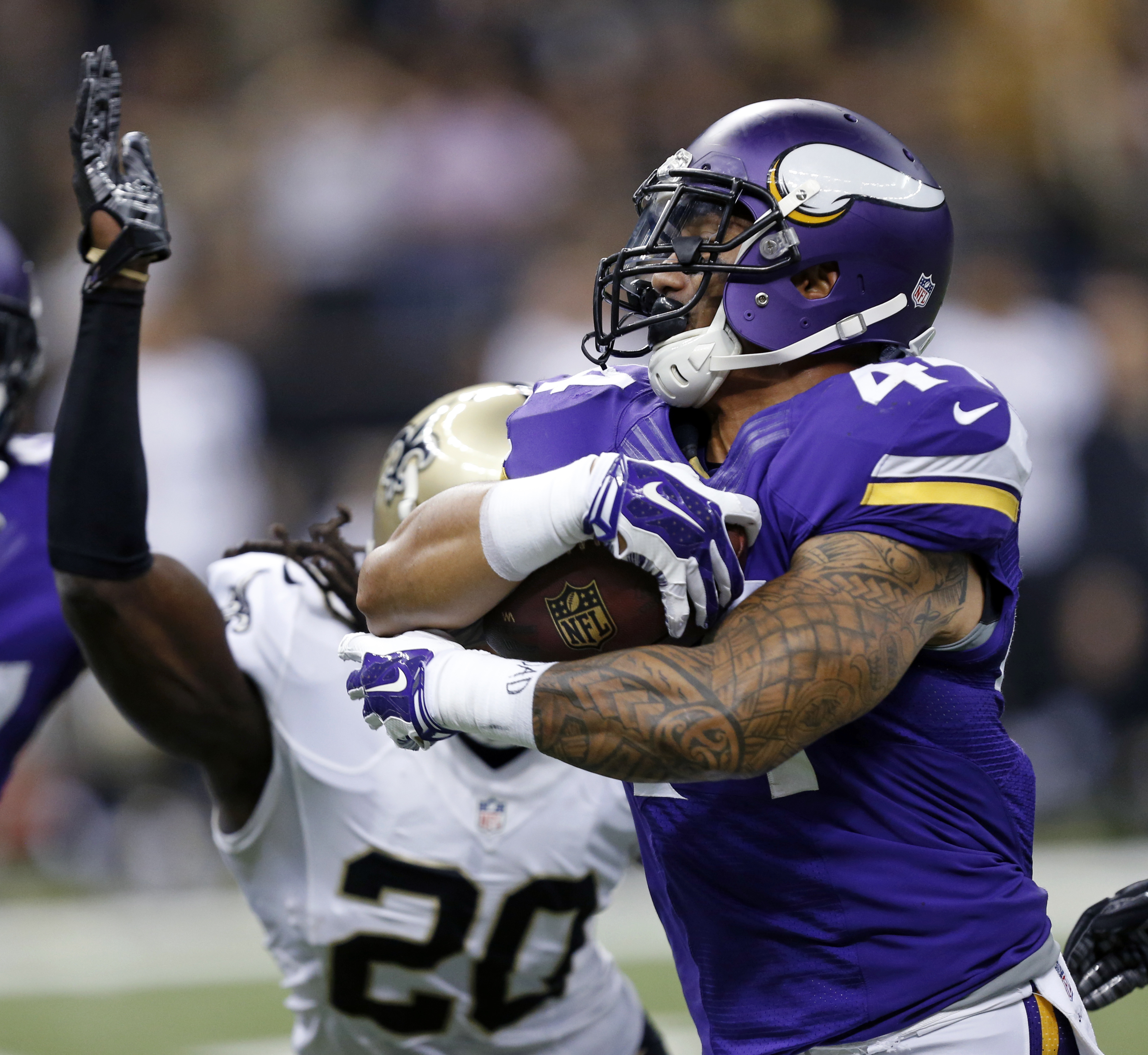 Minnesota Vikings running back Matt Asiata (44) carries the ball past New Orleans Saints defensive back A.J. Davis (20) in the first half of an NFL football game in New Orleans, Sunday, Sept. 21, 2014. (AP Photo/Rogelio Solis)
