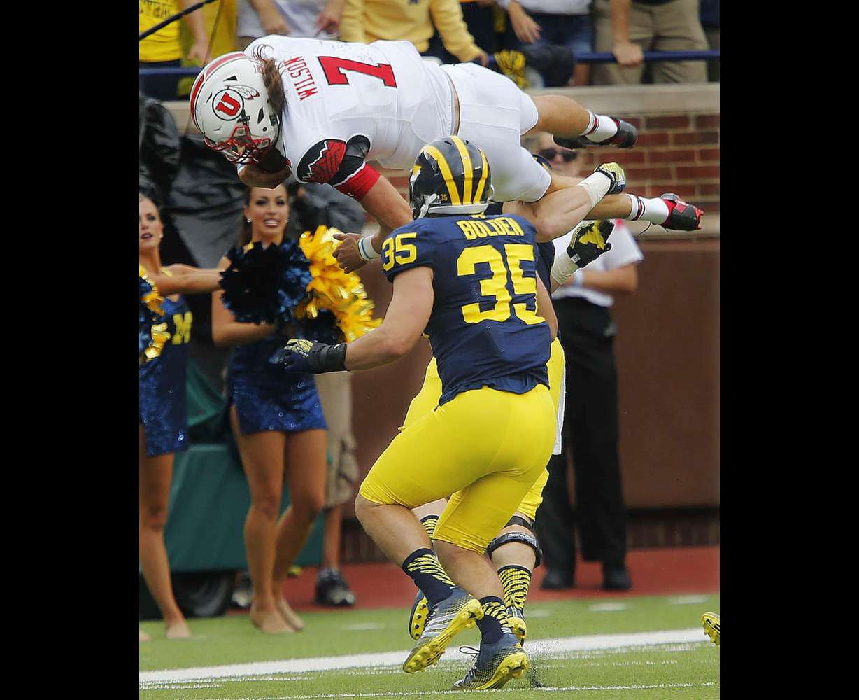 Utah Utes quarterback Travis Wilson (7) dives for a first down as Michigan Wolverines linebacker Jake Ryan (47) tackles him in Ann Arbor, Michigan Saturday, Sept. 20, 2014. Wilson was injured on the play.