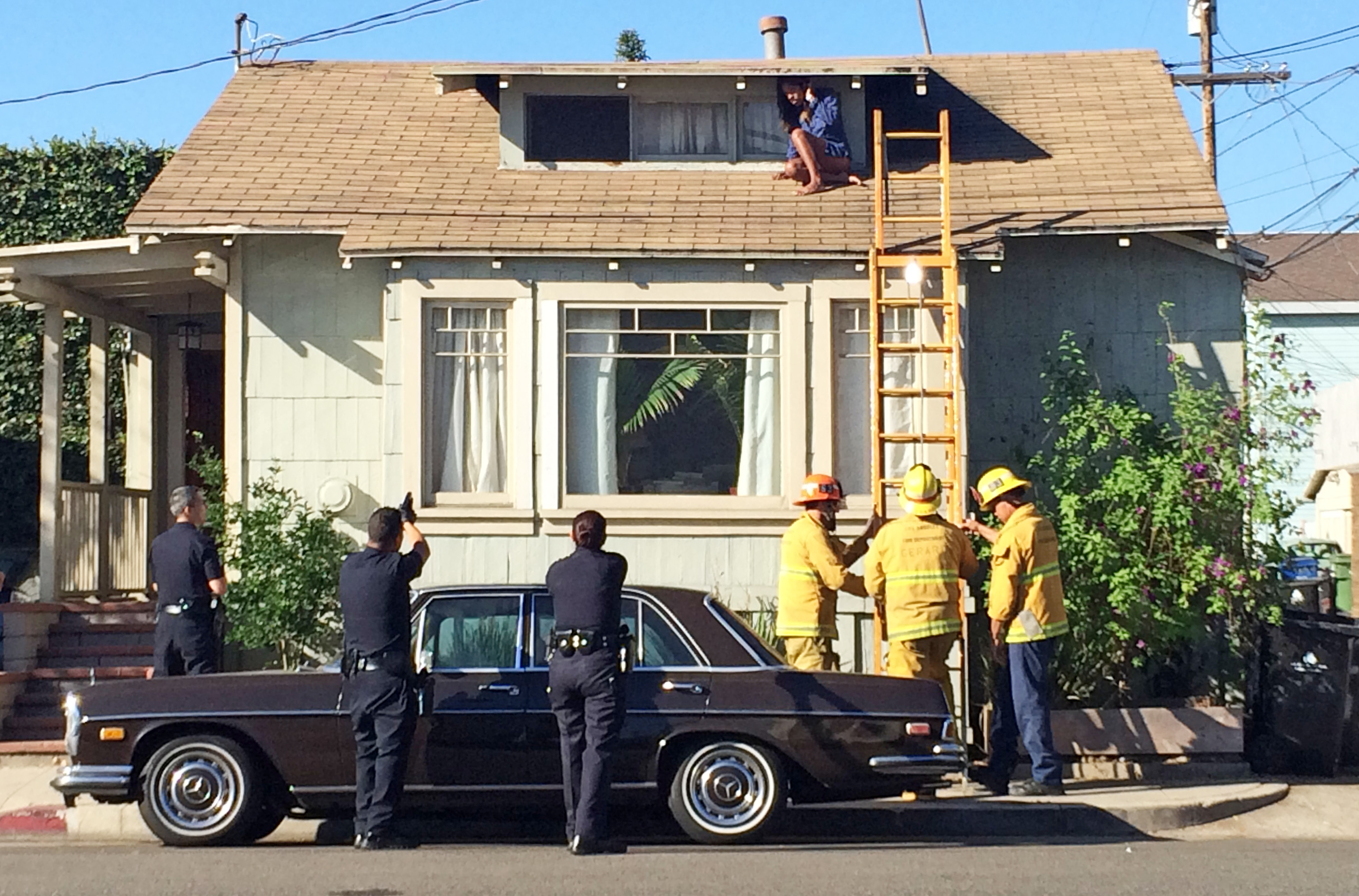 LA woman evades intruder by climbing onto roof