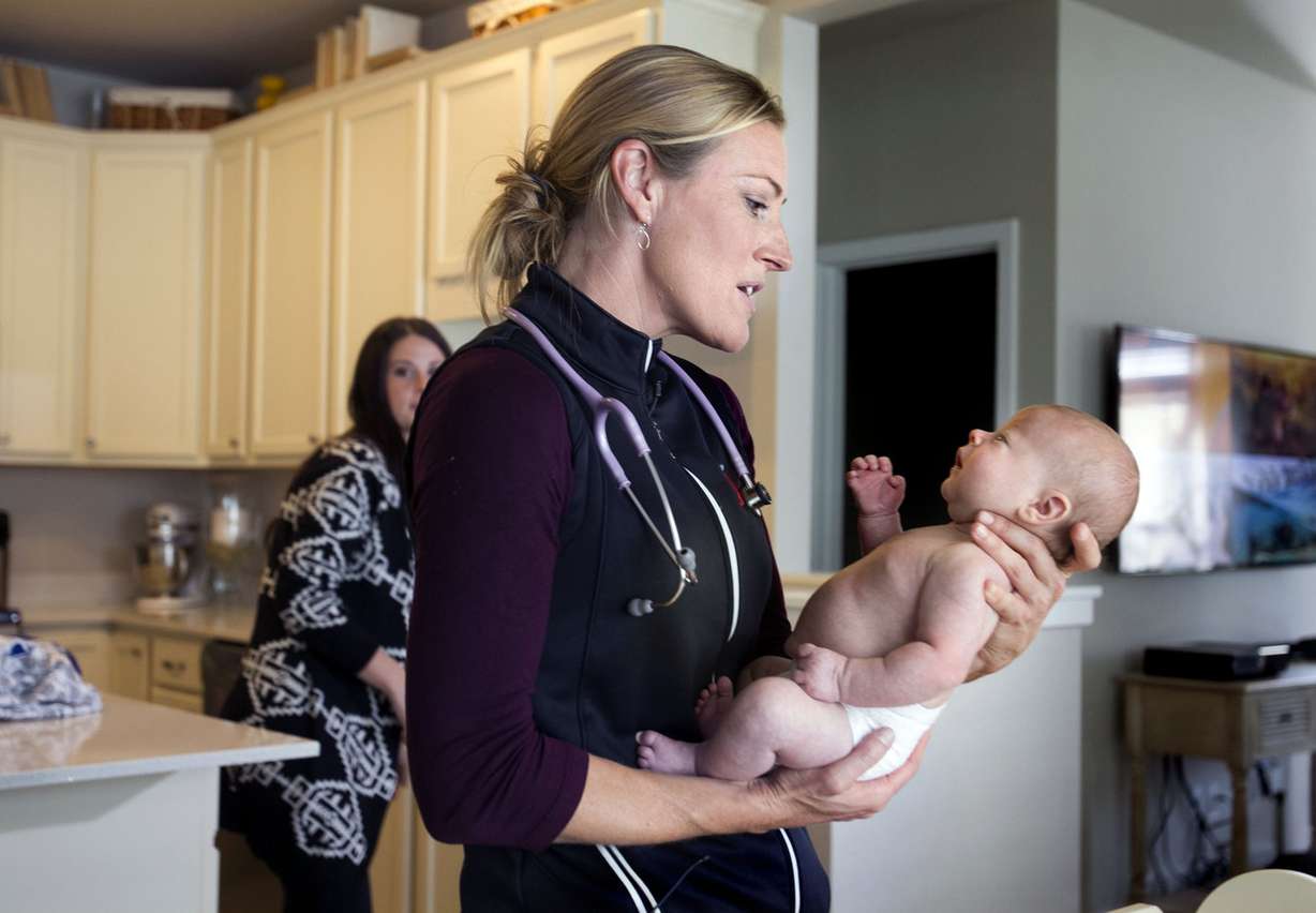 Dr. Amy Williams holds 5-week-old Ander Van Dyke during a demonstration of what happens during a home health checkup in the Van Dykes' South Jordan home on Thursday, Sept. 25, 2014. University of Utah Health Care has recently started offering home visits for newborns. (Photo: Laura Seitz, Deseret News)