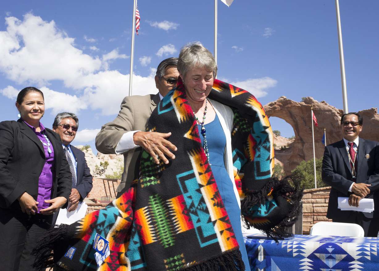 Navajo Nation President Ben Shelly presents Secretary of the Interior Sally Jewell with a blanket after signing the $554 million settlement, Sept. 26, 2014, at Window Rock Veterans Memorial Park.