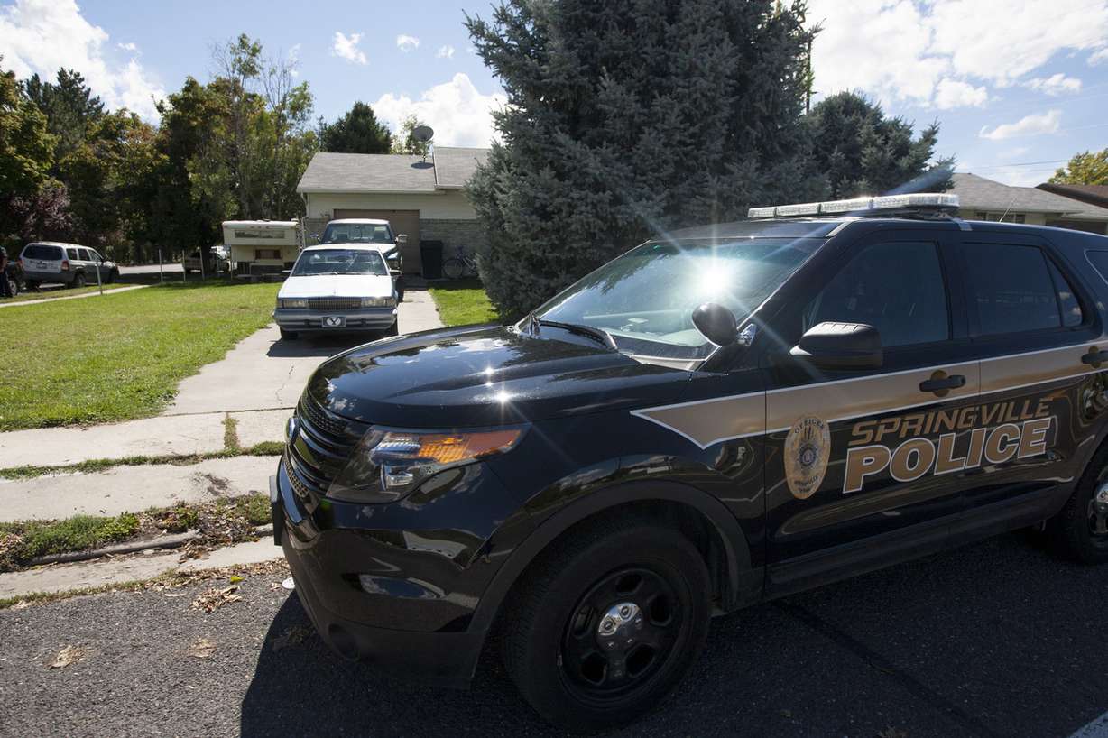 A police vehicle sits outside of 954 E. 900 South in Springville, where a family of five was found dead, Sunday, Sept. 28, 2014. (Photo: Michelle Tessier, Deseret News)