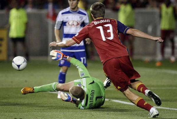 Real Salt Lake forward Justin Braun (13) chases the ball as FC Dallas goalkeeper Kevin Hartman (1) tries to control in Salt Lake City Saturday, Aug. 18, 2012. After a four-team career in MLS, Braun recently helped expansion side Sacramento Republic FC win a USL Pro championship Saturday, and will face RSL in a friendly Tuesday.