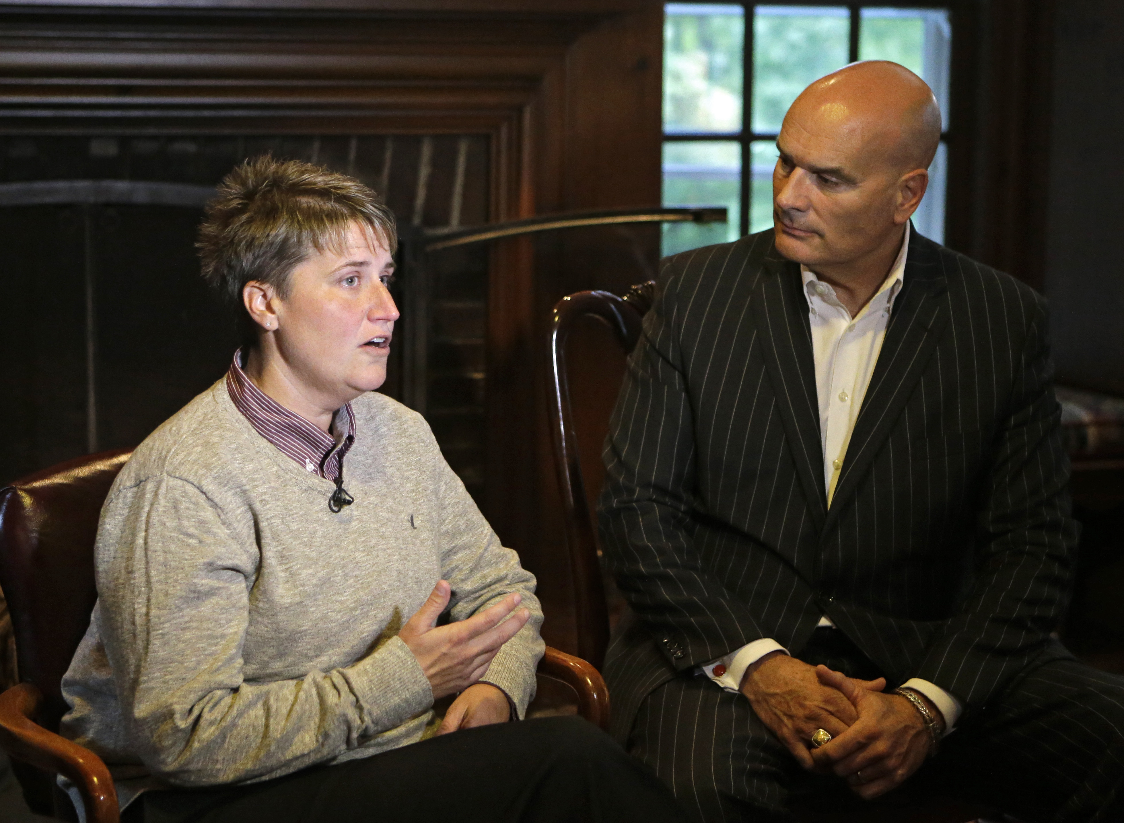 Jennifer Cramblett is interviewed at the home of her attorney, Tim Misny, right, in Waite Hill, Ohio Wednesday, Oct. 1, 2014. Cramblett has sued a Chicago-area sperm bank after she became pregnant with sperm donated by a black man instead of a white man as she'd intended.
