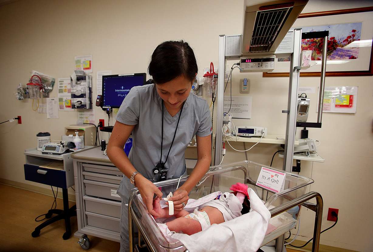Alexa Fackrell, CNA, places a pulse oximeter onto newborn baby Opal Chandler at the Intermountain Medical Center in Murray on Thursday, Oct. 2, 2014. As of October 1, 2014, a new Utah law requires every newborn infant born in the state to be screened for critical congenital heart disease, or CCHD. Utah joins 38 other states that require this pulse oximetry screening to detect a CCHD shortly after birth. (Photo: Laura Seitz)