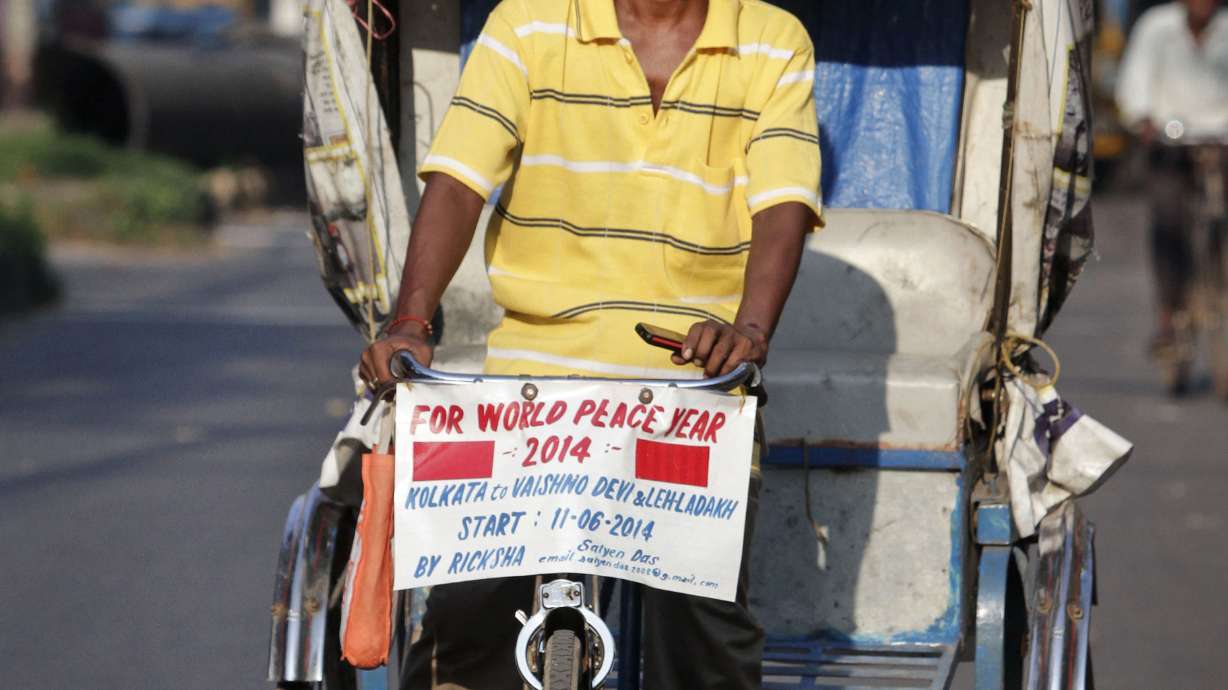 Indian man pedals cycle rickshaw to Himalayan pass