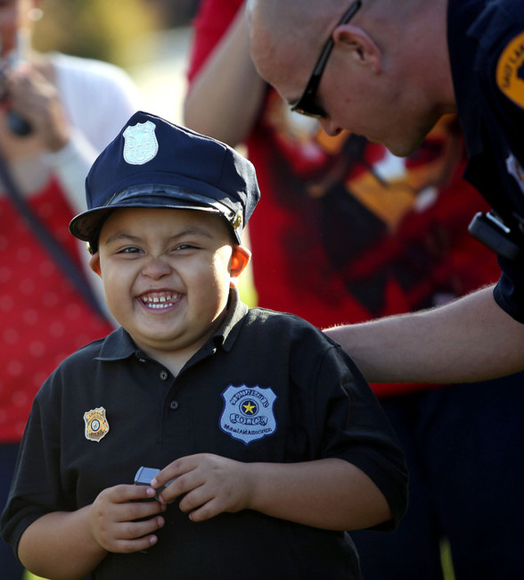 Lucas Aguilar, 5, learns about K-9 dogs with Salt Lake police officer Nick Pearce outside of the Public Safety Building in Salt Lake City on Saturday, Oct. 11, 2014. Aguilar chose to be a police officer for his Make-A-Wish Utah wish. (Kristin Murphy, Deseret News)