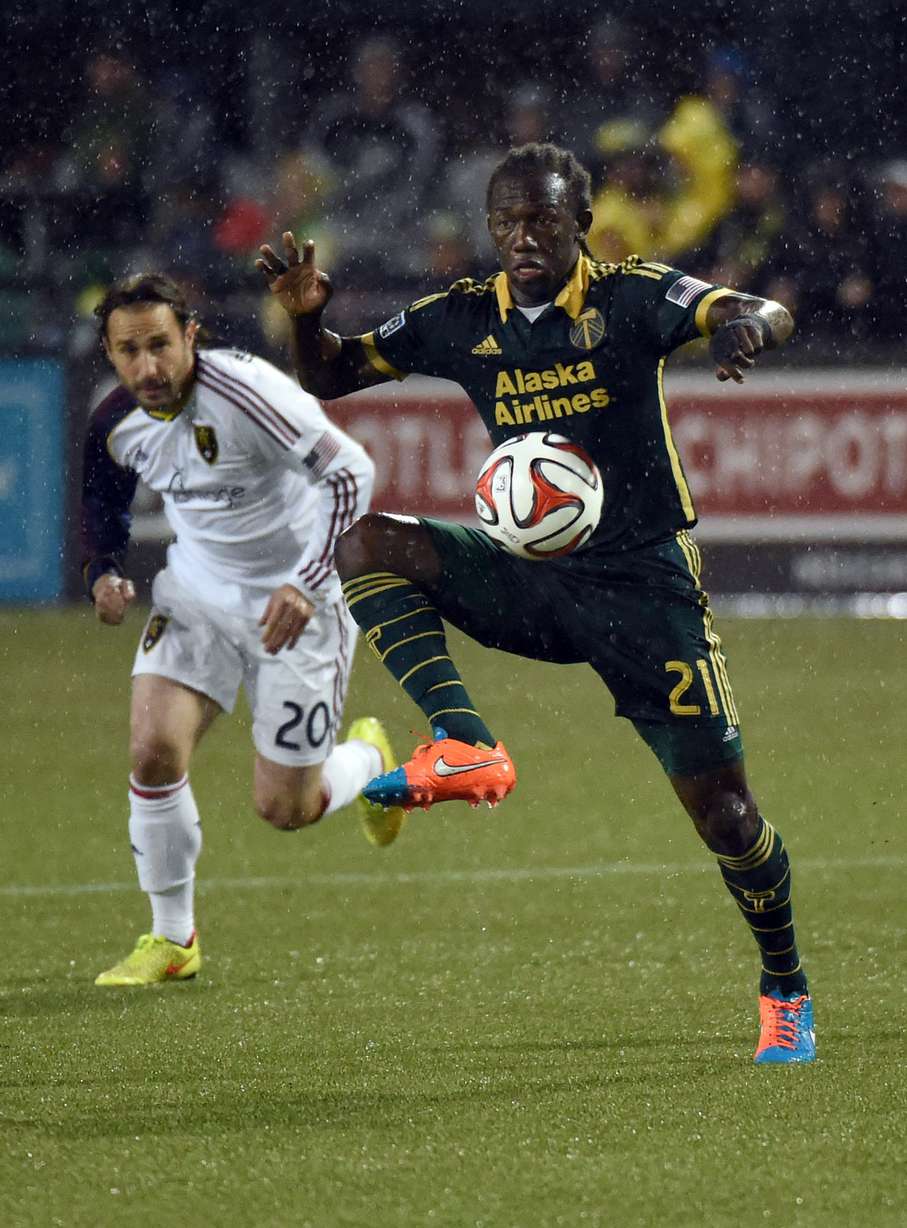 Portland Timbers midfielder Diego Chara (21) controls the ball in front of Real Salt Lake midfielder Ned Grabavoy (20) during the first half of an MLS soccer game on Friday, Oct. 17, 2014, in Portland, Ore. (AP Photo/Steve Dykes)