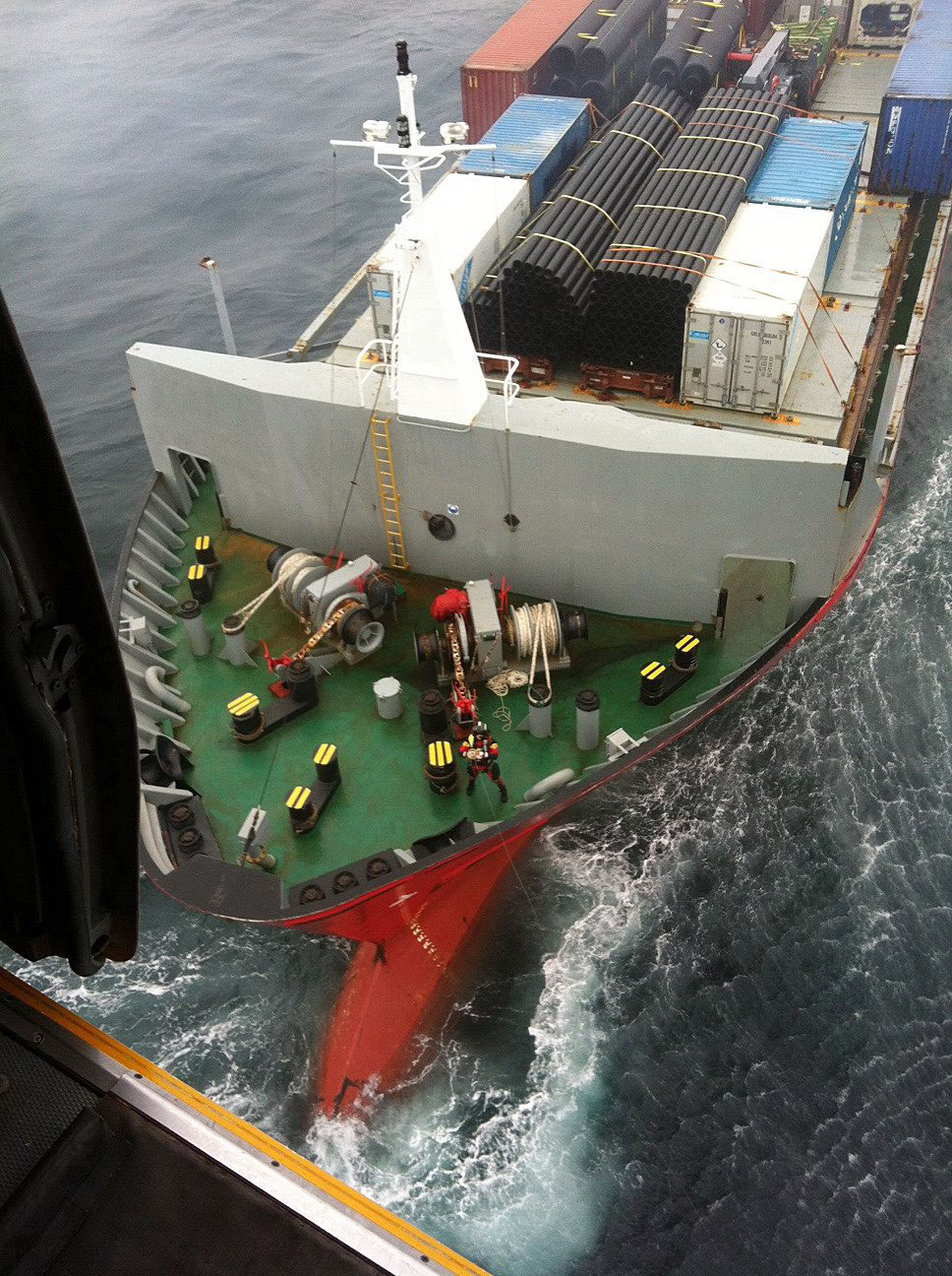 Tug towing disabled Russian container ship to port