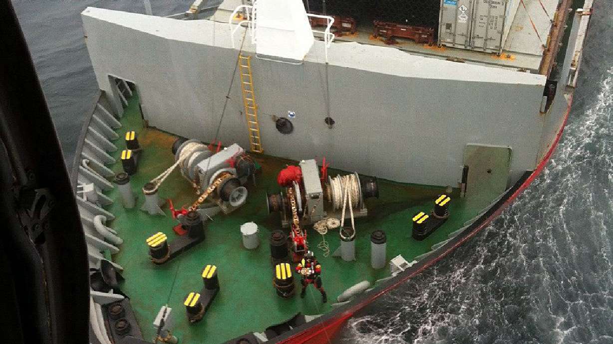 Tug towing disabled Russian container ship to port