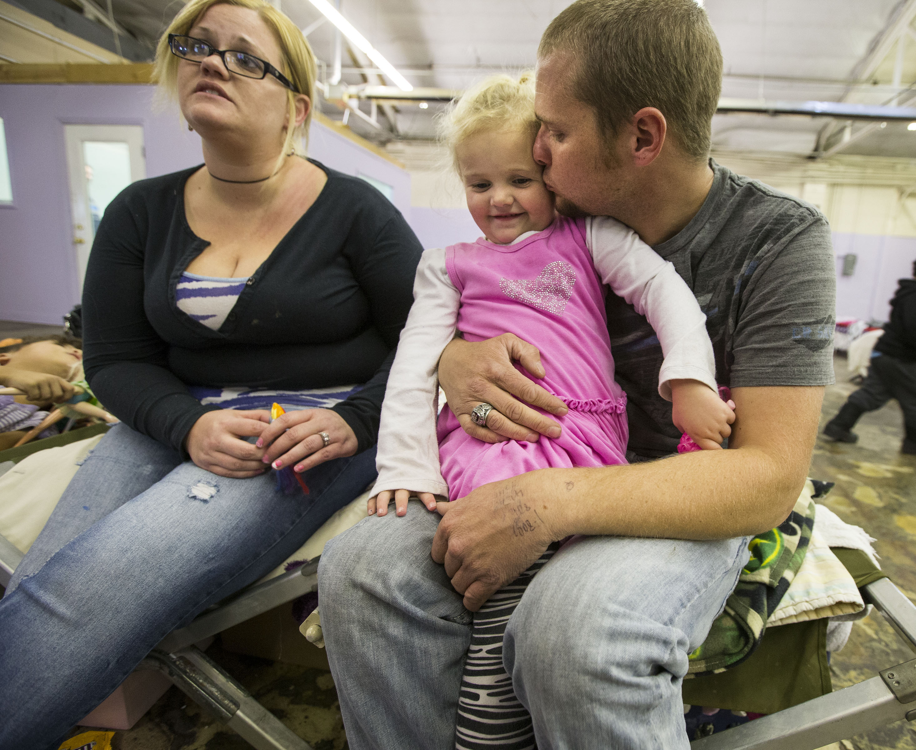 Colby Straub with his wife Annie and their daughter Lilly talk Monday, Nov. 3, 2014, about living in the Midvale Road Home Shelter. (Photo: Scott G Winterton, Deseret News)