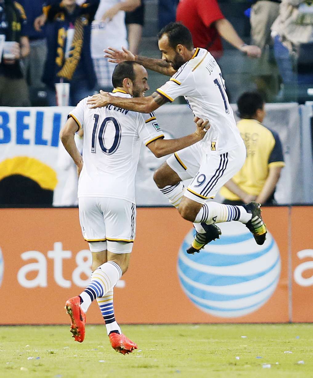 Los Angeles Galaxy's Landon Donovan celebrates after assisting on a goal by teammate Robbie Keane, not pictured, with teammate Juninho, right, against Real Salt Lake during the first half of an MLS soccer Western Conference playoff series in Carson, Calif. (Photo: AP Photo/Danny Moloshok)