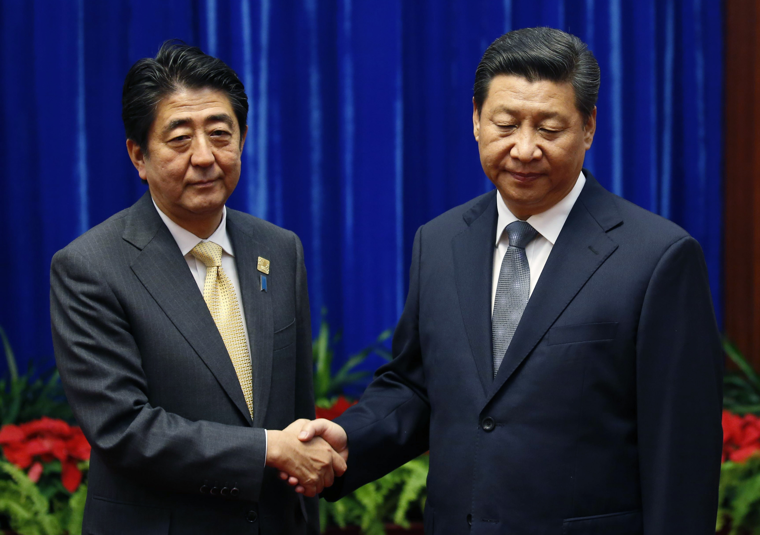 An awkward handshake: Leaders of China, Japan meet