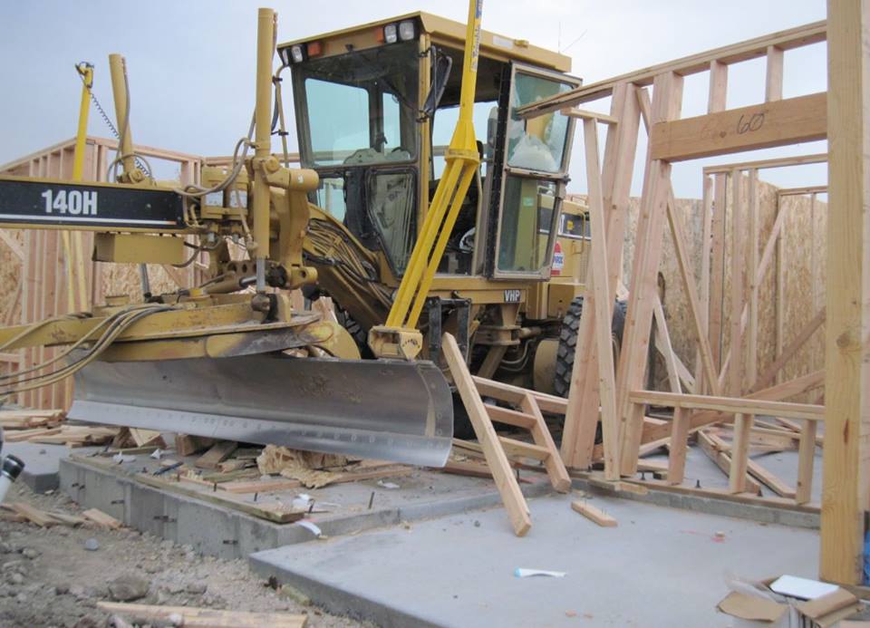 Police seek person who drove road grader through building