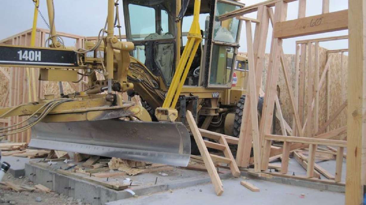 Police seek person who drove road grader through building