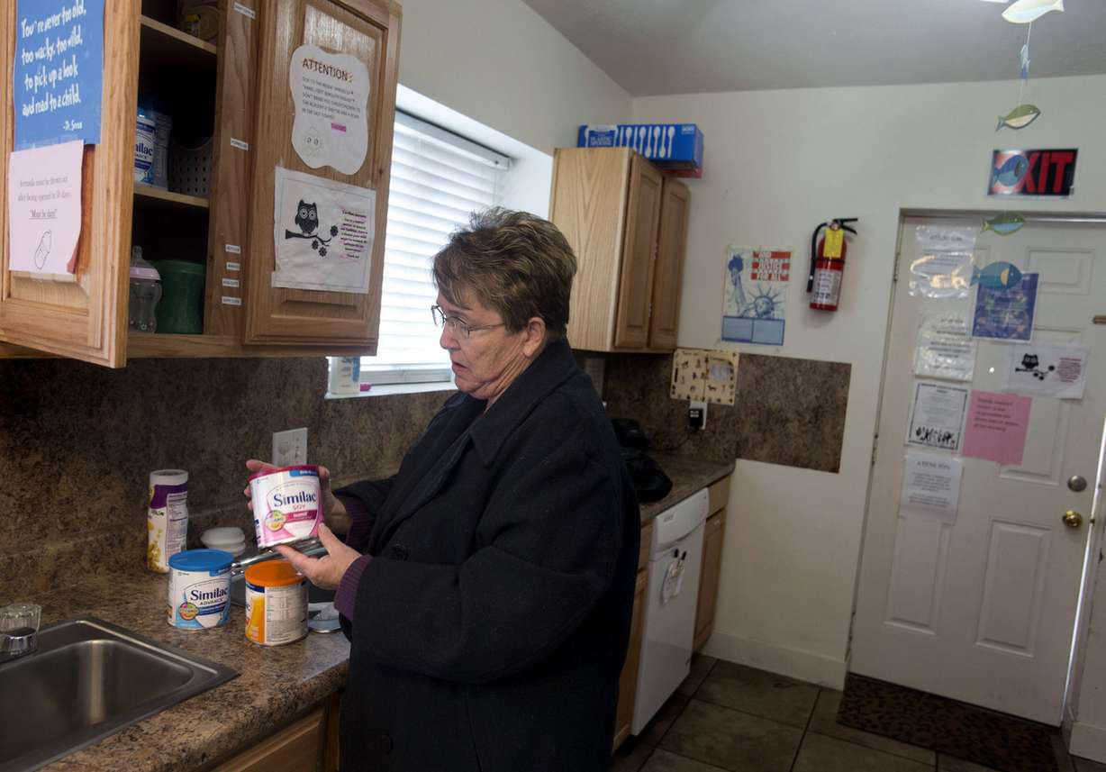 Bonnie Peters, executive director of the Family Support Center, stocks the cupboard with infant formula after running to a local market to purchase formula with her own money at the center in West Valley City on Wednesday, Nov. 12, 2014. The Family Support Center, a private nonprofit organization whose mission is to protect children, strengthen families and prevent child abuse is at an all-time low in having formula to feed the infants who use crisis nurseries in the Salt Lake Valley. (Photo: Laura Seitz, Deseret News)
