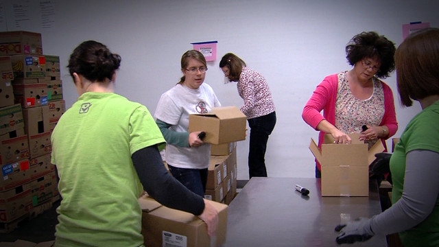 Volunteers help organize boxes of food at the Utah Food Bank. (Photo: KSL TV)