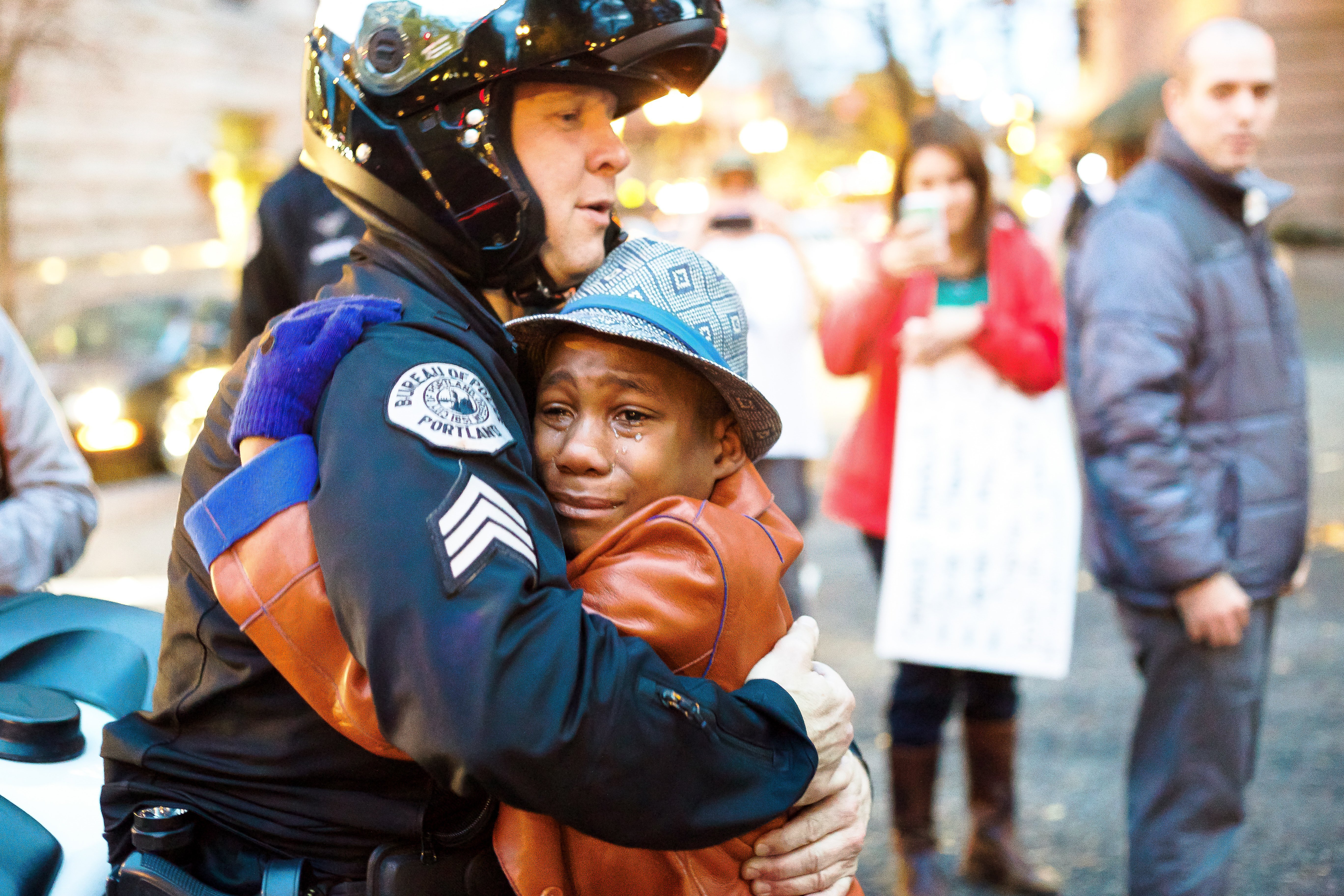 Portland, Oregon police Sgt. Bret Barnum hugs 12-year-old Devonte Hart at a Ferguson, Missouri-related demonstration on Tuesday, Nov. 25, 2014. Full Credit: Johnny Nguyen/www.Chambervisuals.com