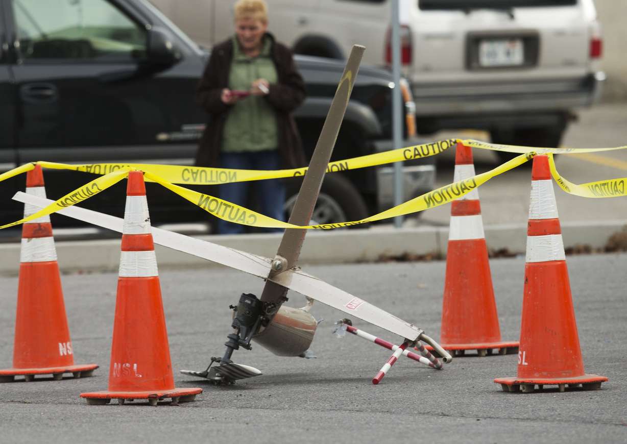 Rescue personnel from multiple agencies work at the crash site of a helicopter that crashed into a building near Sky Park Airport in North Salt Lake Tuesday Dec. 2, 2014. (Photo: Scott G Winterton, Deseret News)