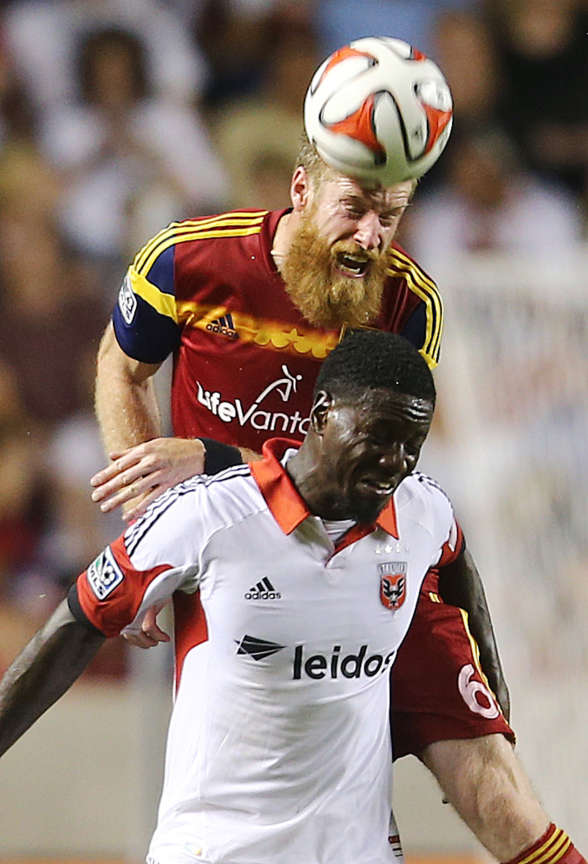 RSL's Nat Borchers goes over Eddie Johnson for a header as Real Salt Lake and DC United play Saturday, Aug. 9, 2014, at Rio Tinto Stadium in Sandy. Borchers was one of three players extended a Bona Fide contract offer by RSL this week, alongside Chris Wingert and Cole Grossman. (Scott G Winterton/Deseret News)
