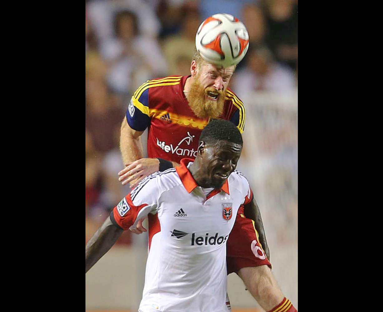RSL's Nat Borchers goes over Eddie Johnson for a header as Real Salt Lake and DC United play Saturday, Aug. 9, 2014, at Rio Tinto Stadium in Sandy. Borchers was one of three players extended a Bona Fide contract offer by RSL this week, alongside Chris Wingert and Cole Grossman. (Scott G Winterton/Deseret News)