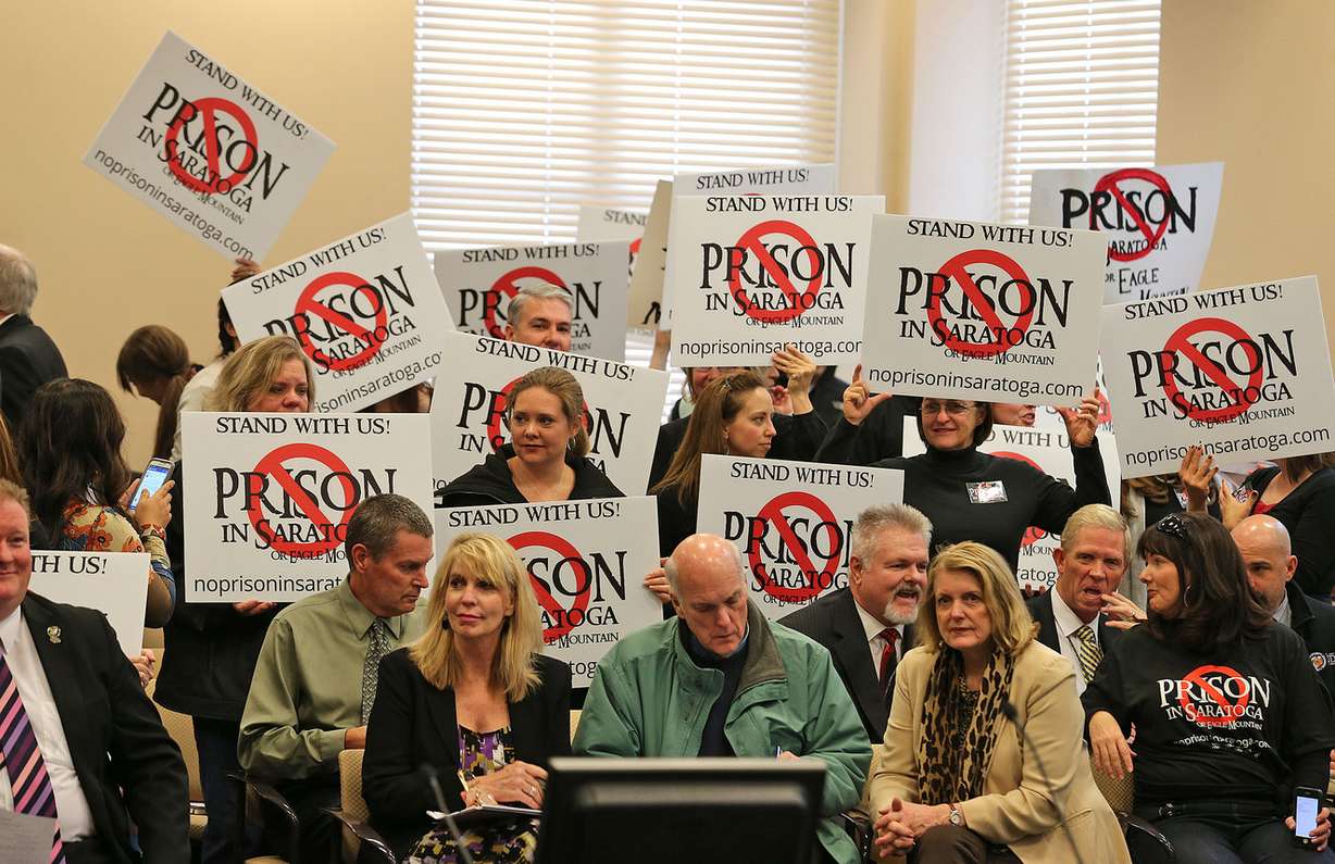 Protesters show their disapproval of relocating the Utah State Prison to near Saratoga Springs at the State Prison Relocation Commission meeting at the Utah Senate Office Building Wednesday, Dec. 3, 2014, in Salt Lake City.
(Photo: Tom Smart, Deseret News)