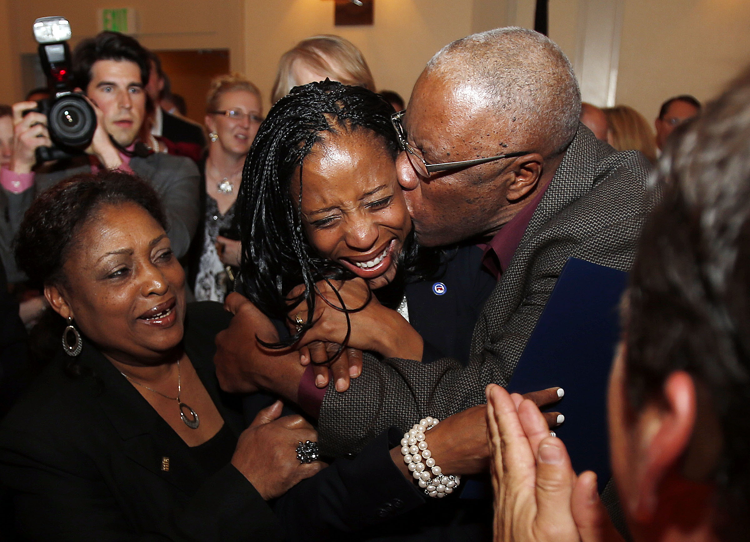 Mia Love, 4th Congressional District Republican candidate, is congratulated by her father Maxime Bourdeau as she declares victory on election night in Salt Lake City, Tuesday, Nov. 4, 2014. At left is Mia's mother, Marie Bourdeau. (Ravell Call, Deseret News)