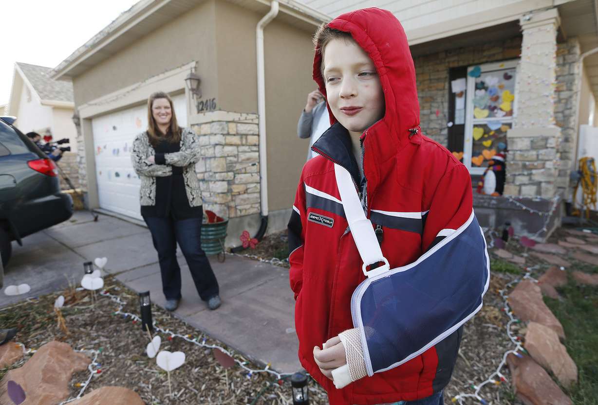 Kollin Bailey talks about his recent experience as his mother Shara listens in Herriman on Saturday, Dec. 6, 2014. Bailey was flying a kite and fell down a manhole near his home Friday but was found by a West Valley police K-9 dog. (Photo: Jeffrey D. Allred, Deseret News)