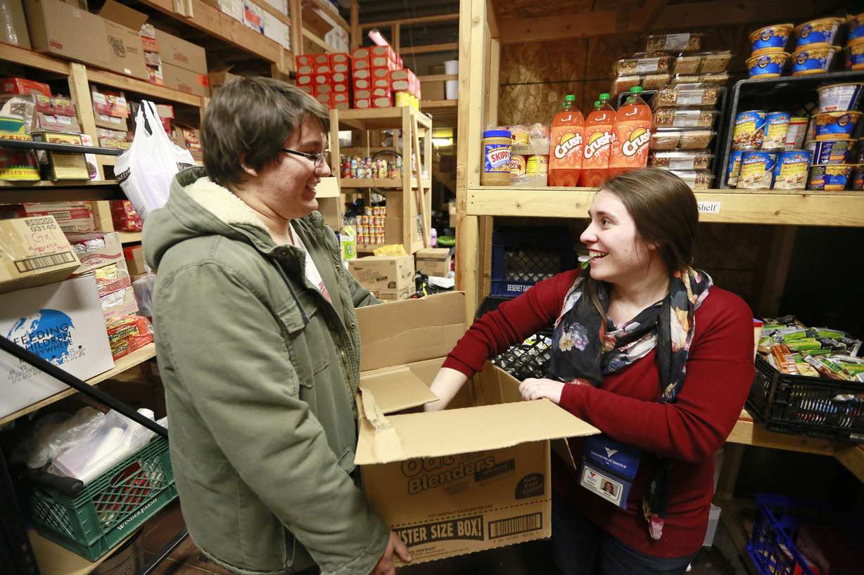 Homeless Youth Resource Center employees Anna Stapley, right, and Dylan Jarosz restock food supplies at the facility on Friday, Dec. 5, 2014, in Salt Lake City. (Photo: Hugh Carey, Deseret News)