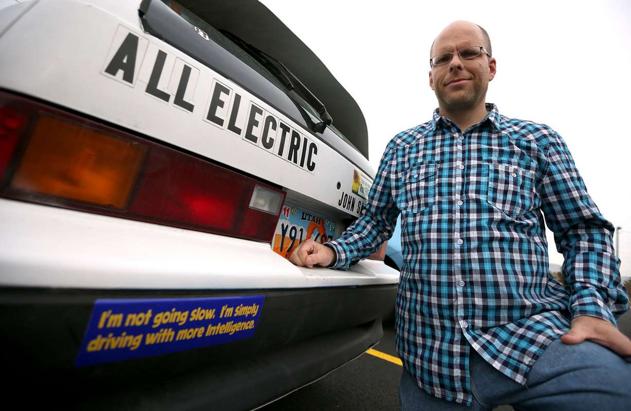John Loveless poses for a photo with his Geo Metro that he converted to an all-electric vehicle, in Salt Lake City on Tuesday, Dec. 2, 2014. (Photo: Kristin Murphy, Deseret News)