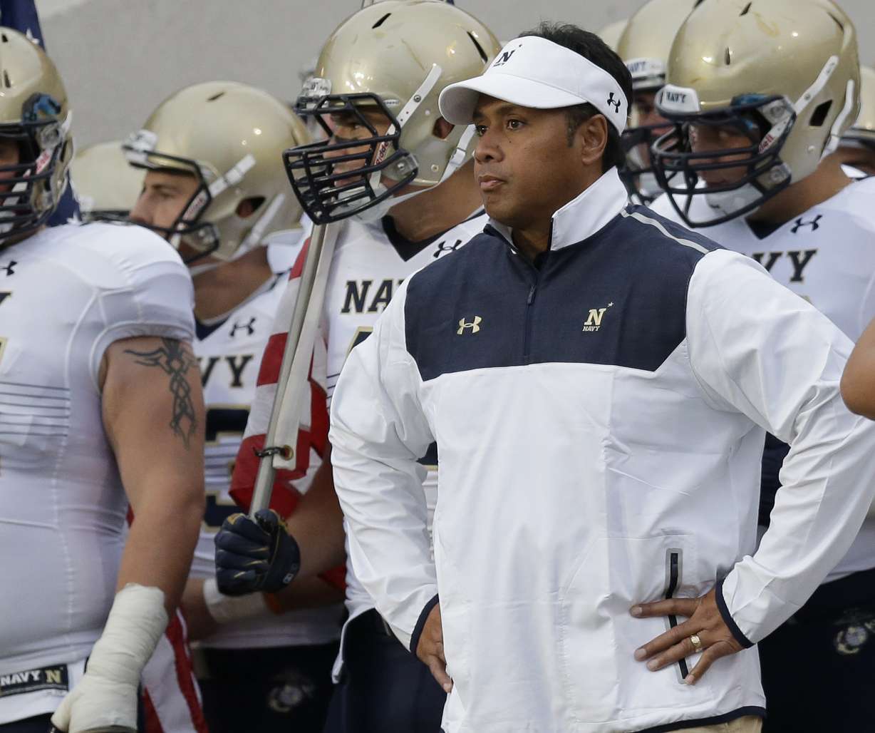 This Sept. 13, 2014, file photo shows Navy head coach Ken Niumatalolo standing with his team prior to an NCAA college football game against Texas State in San Marcos, Texas. (AP file photo)
