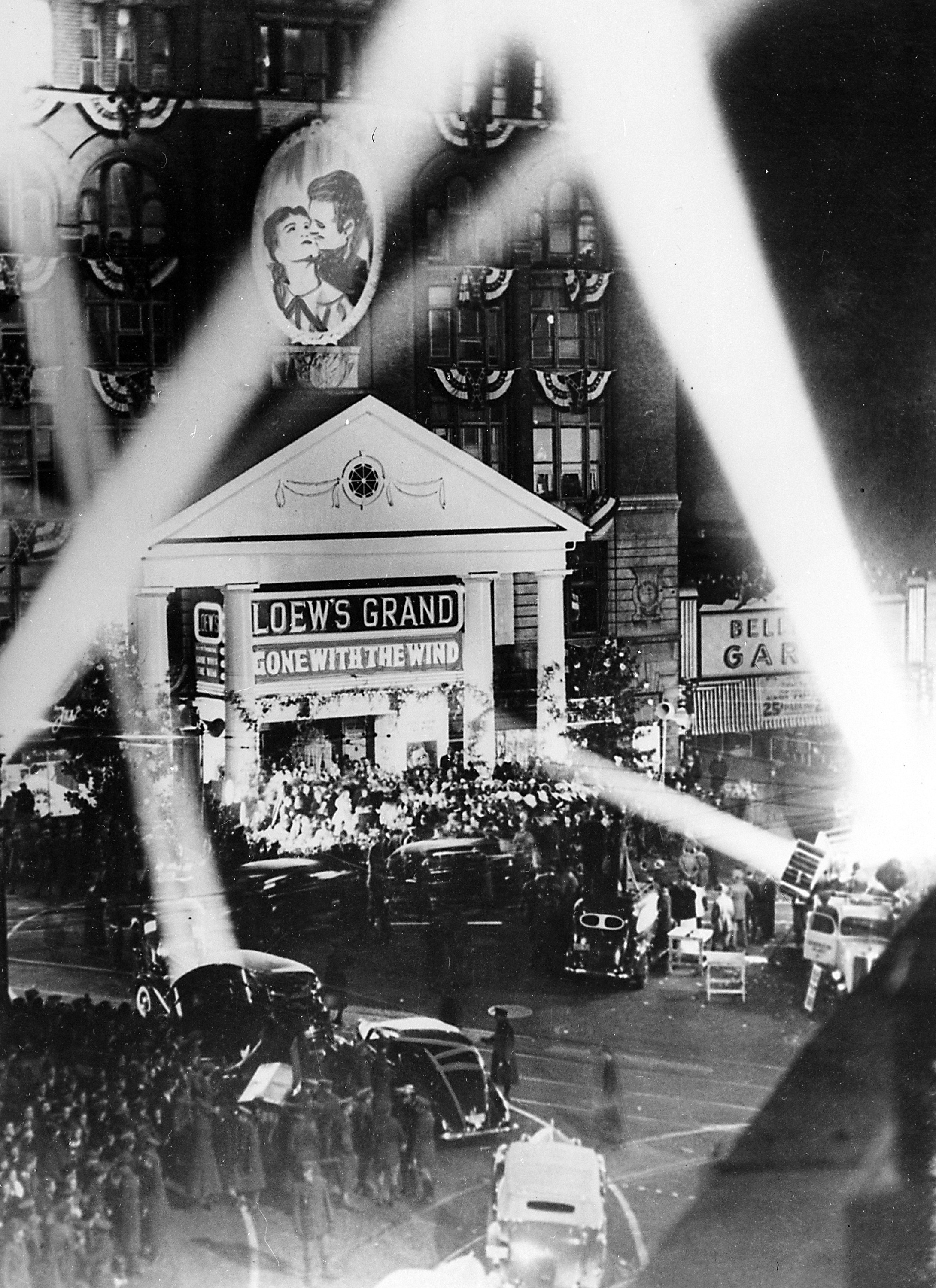 FILE - In this Dec. 15, 1939 file photo, searchlights frame the Tara facade of the Loews Grand Theater on Peachtree St. for the movie premiere of Gone With the Wind in Atlanta.