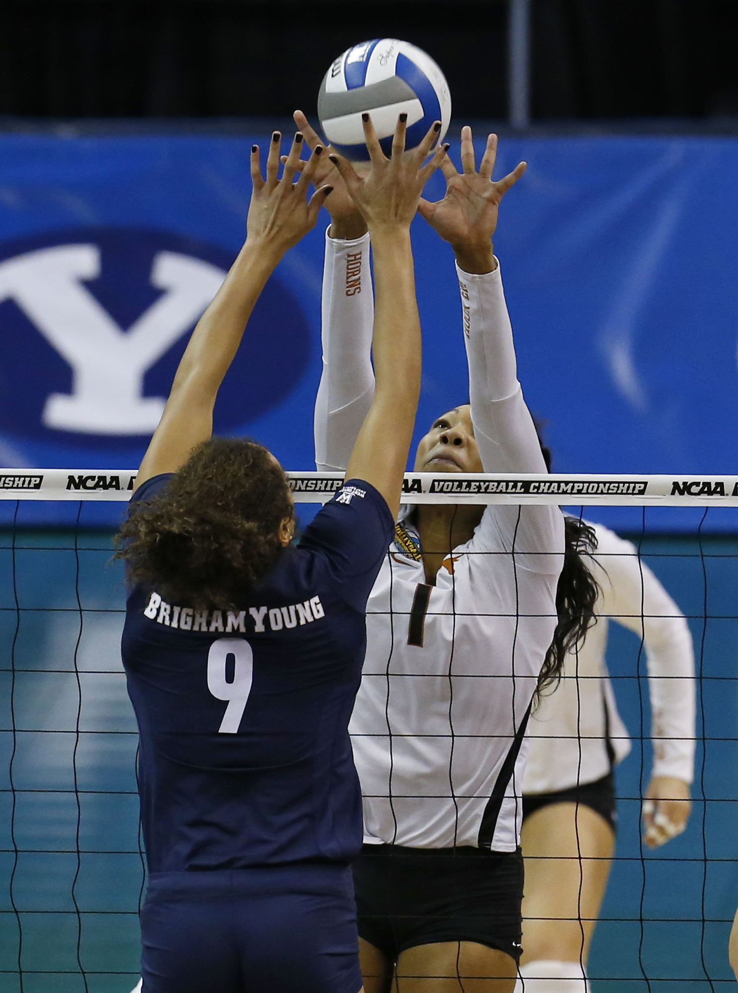 BYU's Alexa Gray (9) and Texas's Khat Bell (1) go up for the ball during an NCAA college volleyball tournament semifinal in Oklahoma City, Thursday, Dec. 18, 2014. (AP Photo/Sue Ogrocki)
