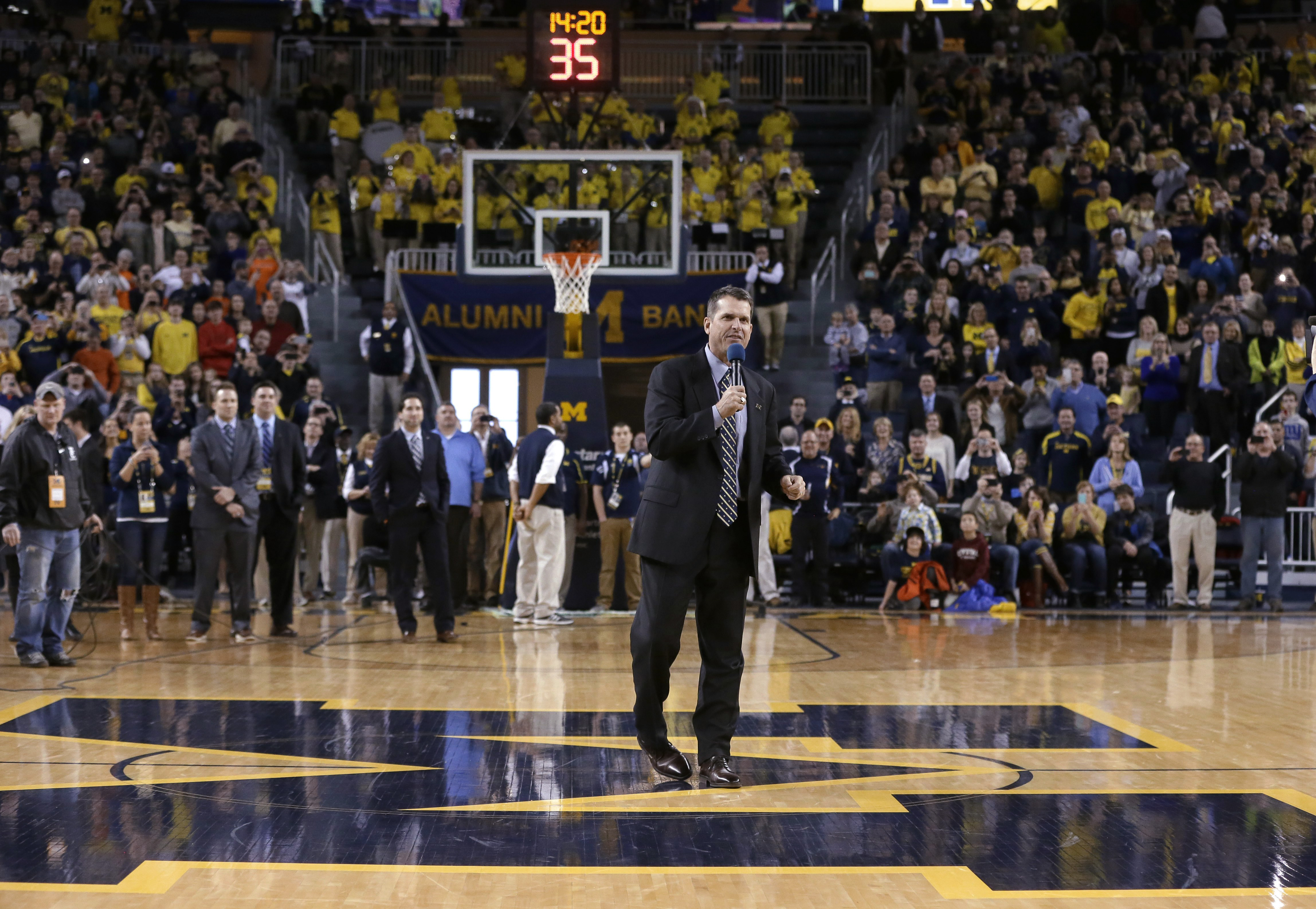 Harbaugh watches Michigan top Illinois 73-65 in OT