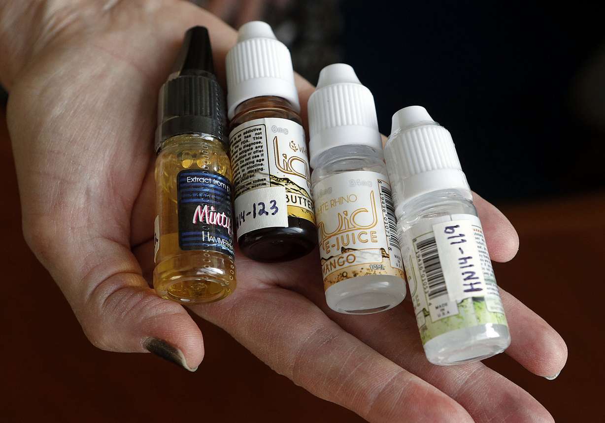 Kathy Garrett of the Salt Lake County Health Department shows a few samples of e-juice, used in e-cigarettes, Thursday, Jan. 8, 2015. 153 samples were purchased from vendors in Salt Lake County and were tested by the Center for Human Toxicology at the University of Utah to determine the amount of nicotine in each sample. (Photo: Ravell Call, Deseret News)