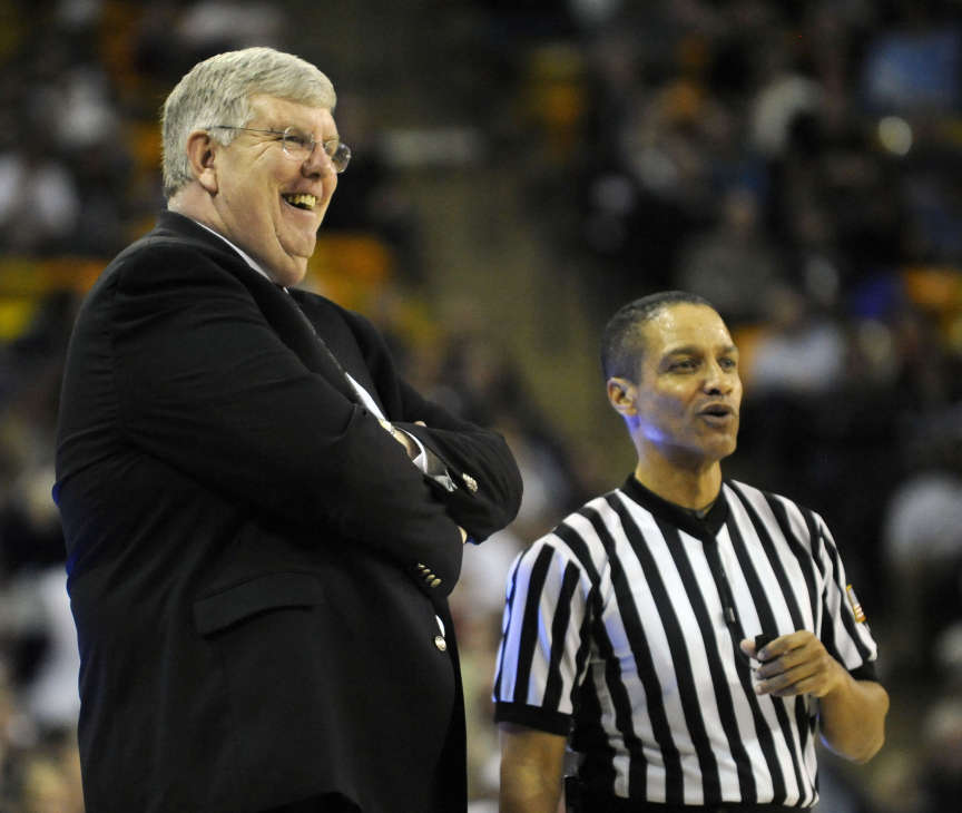 Utah State head coach Stew Morrill has a laugh with an official during a game between the Aggies and Colorado State at the Dee Glen Smith Spectrum in Logan on Wednesday, January 15, 2014. After 17 years at Utah State, Morrill is expected to retire at the end of this season. (Matt Gade/Deseret News)
