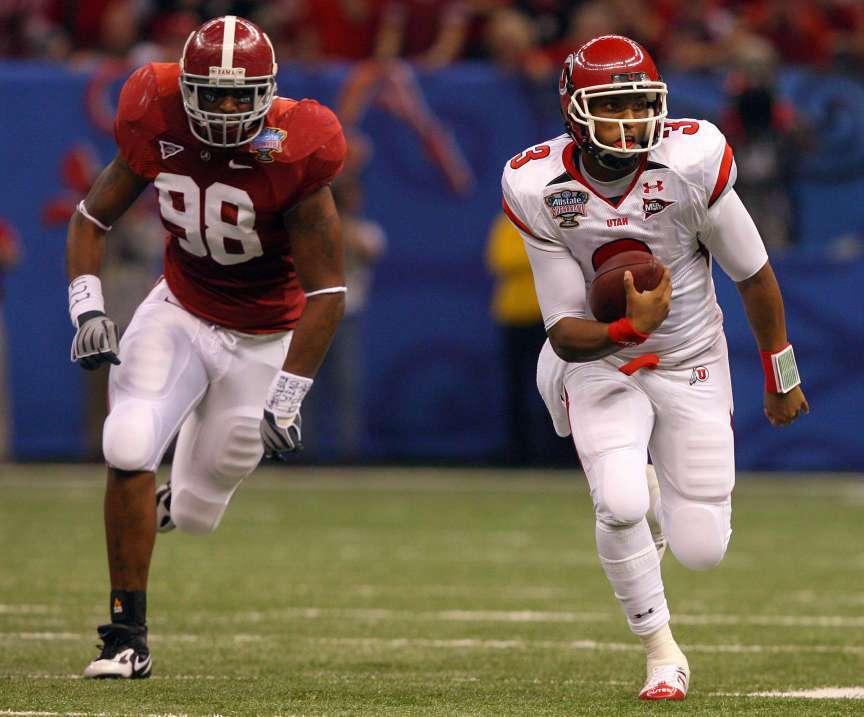 Utah quarterback Brian Johnson (3) runs for a first down with Alabama linebacker Brandon Fanney (98) during the first half of the 2009 Allstate Sugar Bowl. Utah won 31-17. (Scott G. Winterton, Deseret News)