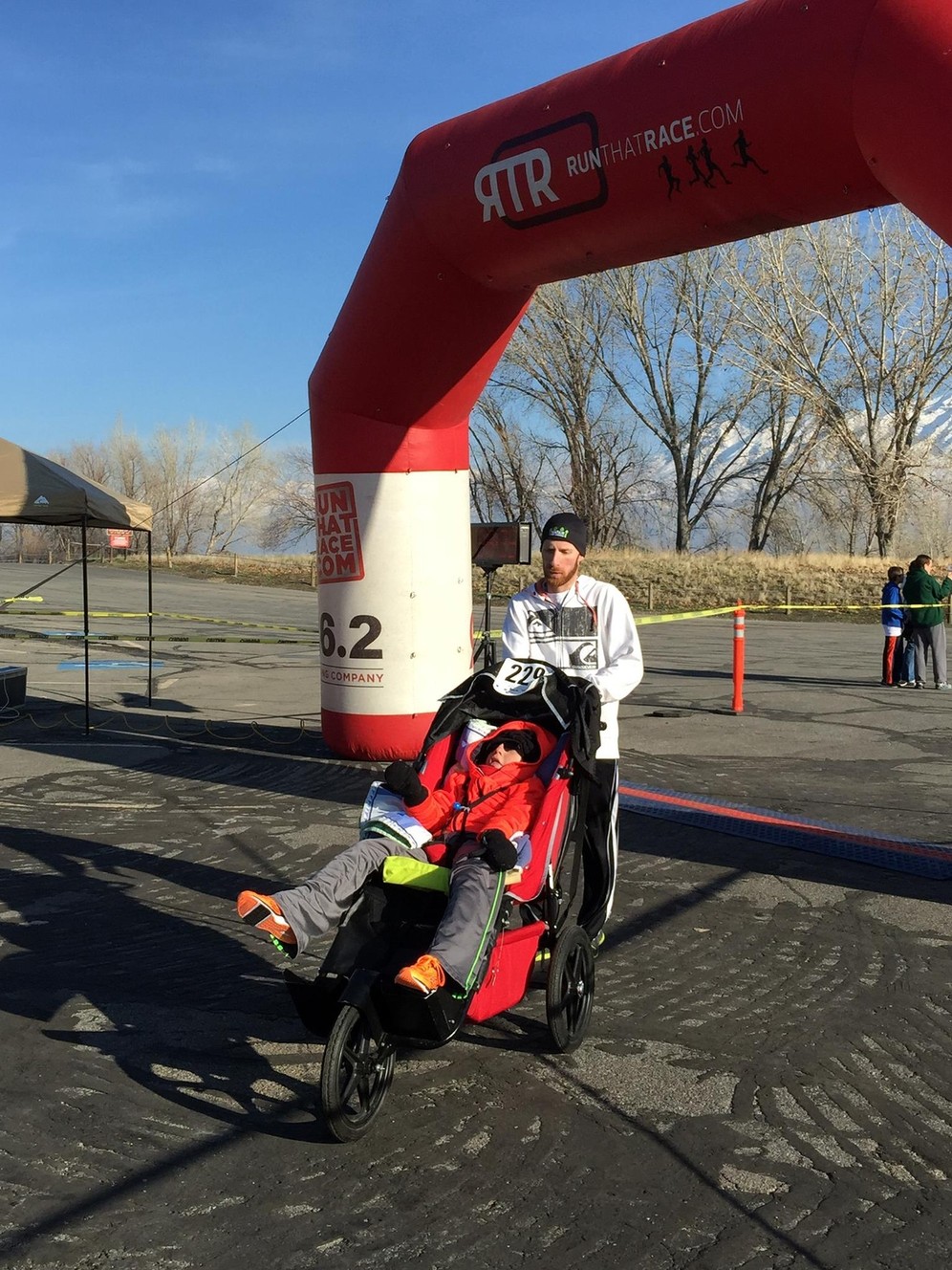Reese Thorne crosses the finish line of the Frigid 5K, pushed by his older brother, Michael. (Photo: Carla Thorne)