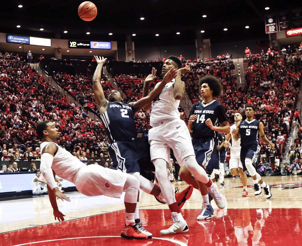 Utah State guard Darius Perkins, shown here against San Diego State guard Aqeel Quinn, left, was Utah State's co-leading scorer in the Aggies' 85-79 win over Fresno State on Saturday for their season-high fourth win in a row. (AP Photo/Lenny Ignelzi/File)