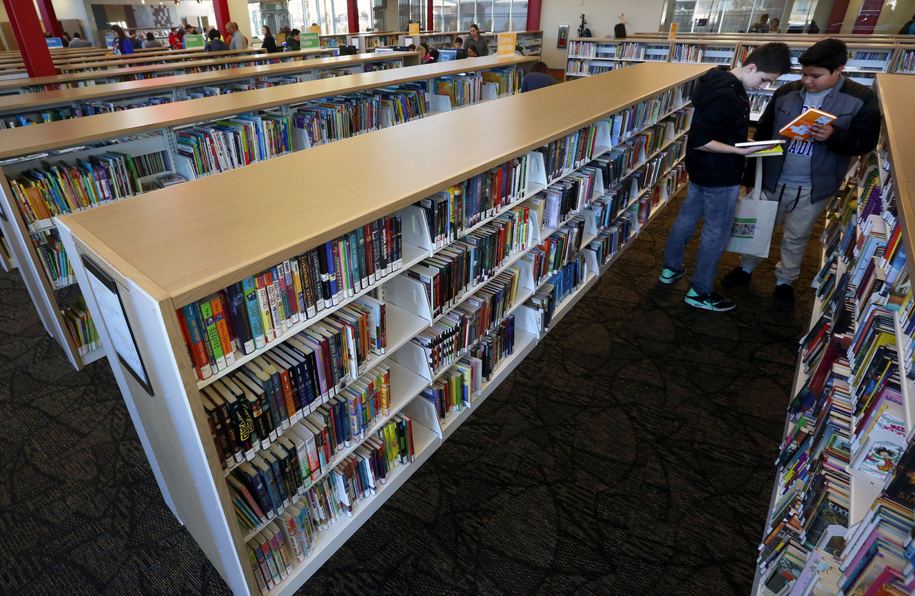 Emmanuel Gutierrez and Esteban Moreno look at books during the grand opening of the Salt Lake City Library System's newest location, the Glendale Branch, in Salt Lake City on Saturday, Feb. 7, 2015. (Photo: Kristin Murphy, Deseret News)