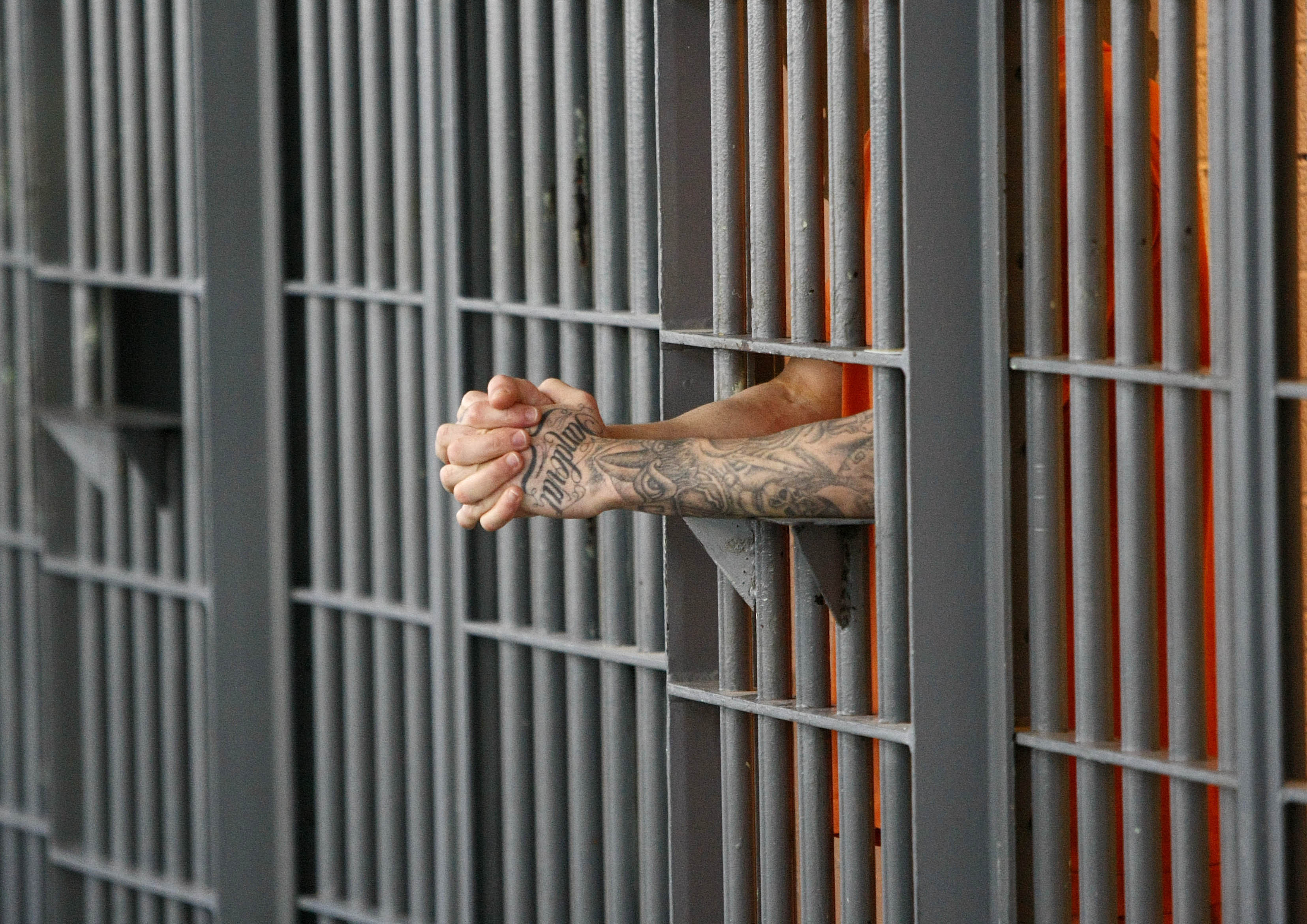 Man in jail hands handcuffs AP file photo prison sentence inmate cell door